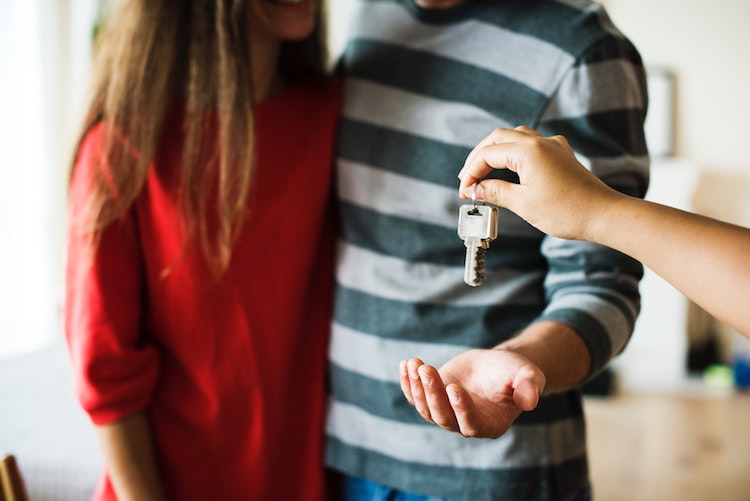Couple getting keys for new house.