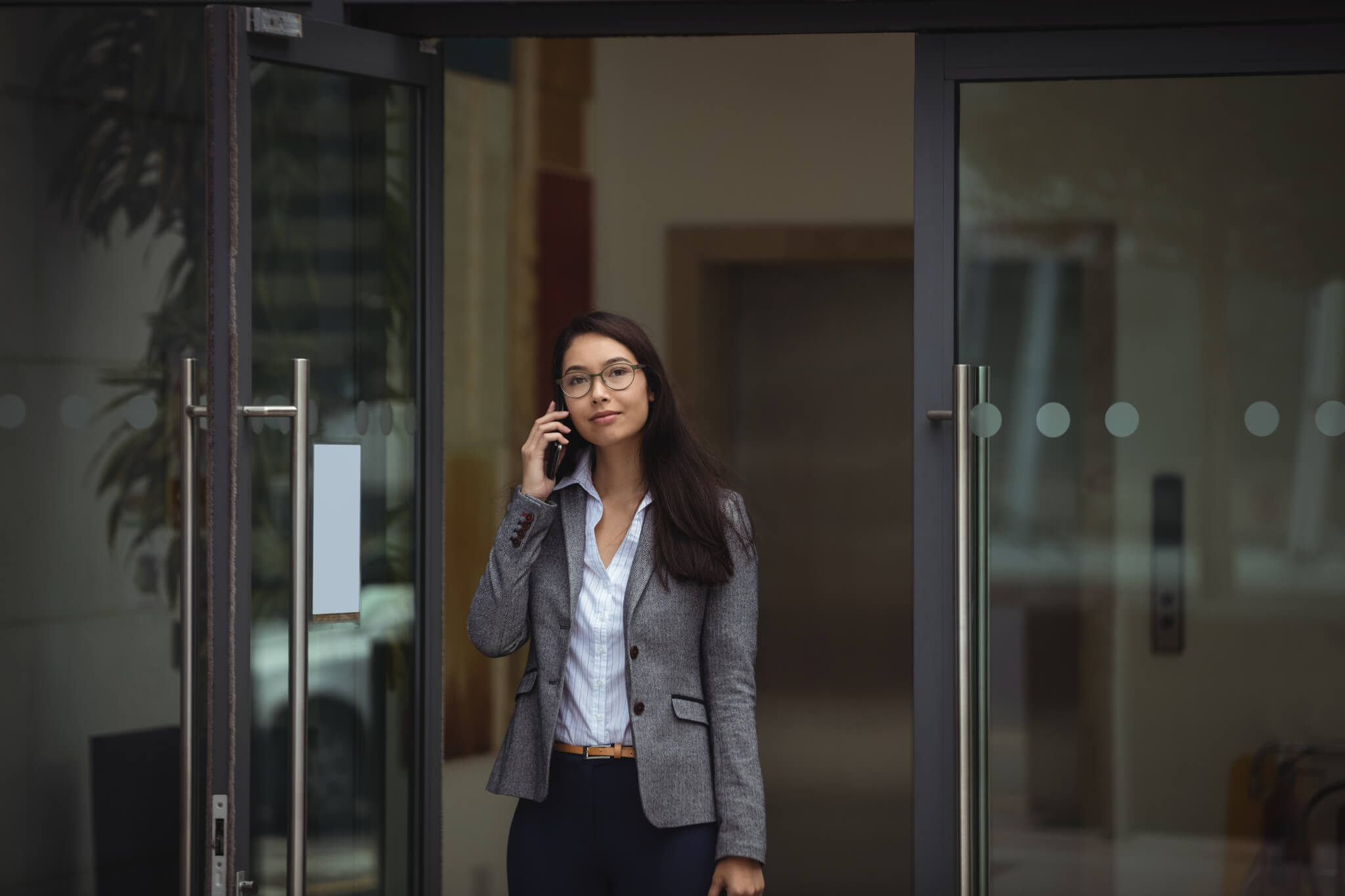 Contractor talking on mobile phone outside office building