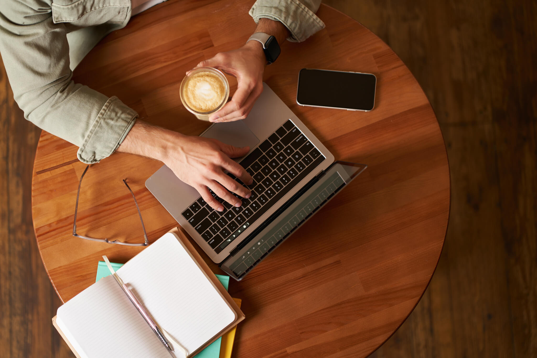 Limited company owner working from a cafe with a coffee
