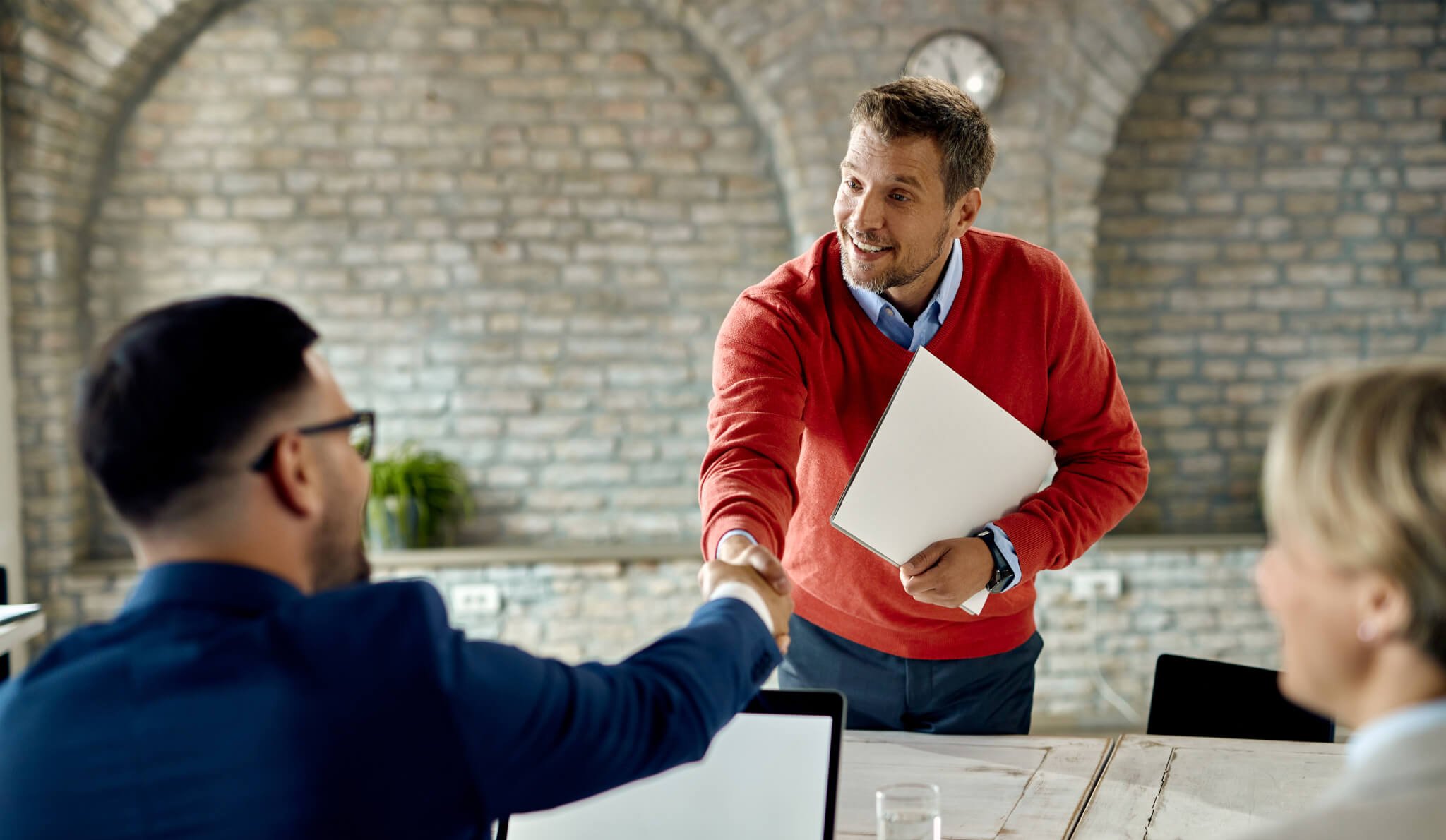 Contractor shaking end client's hand