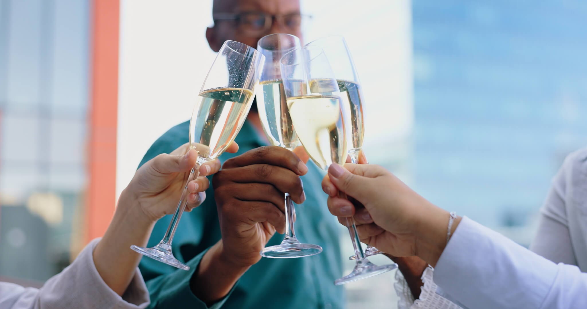 Employees celebrating with champagne at a corporate party