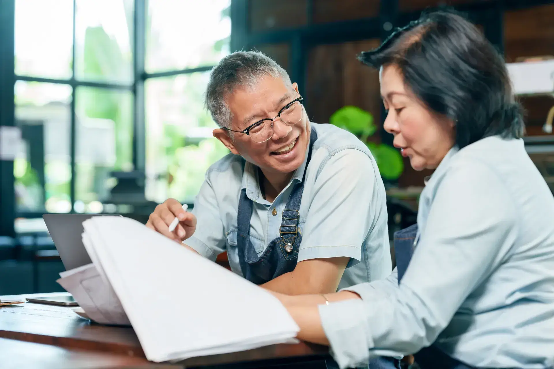 a-happy-couple-working-through-paperwork | SG Accounting A happy couple working through paperwork